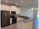 Modern kitchen featuring white cabinets, sleek countertops, and stainless steel appliances at 1077 Quaker Ridge Ln, Davenport, FL 33896