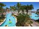 Enjoy this gorgeous lazy river featuring lush tropical landscaping and a bridge for traversing from one side to the other at 1077 Quaker Ridge Ln, Davenport, FL 33896