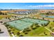 Aerial view of community tennis courts with green turf and plenty of courts to enjoy the game with neighborhood friends at 1077 Quaker Ridge Ln, Davenport, FL 33896