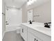 Bright bathroom featuring double sink vanity with modern fixtures, and a tub with white tiled walls at 199 Bull Frog Ln, Umatilla, FL 32784
