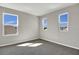 Bright bedroom with three windows offering natural light and plush carpet at 199 Bull Frog Ln, Umatilla, FL 32784