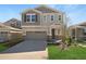 Charming two-story home showcasing a manicured lawn and a neutral color scheme with stone accents at 199 Bull Frog Ln, Umatilla, FL 32784