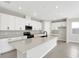 Bright, modern kitchen with a large island, white cabinets, and stainless steel appliances at 199 Bull Frog Ln, Umatilla, FL 32784