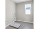 Neutral-colored laundry room with a window for lots of natural light and tile flooring at 199 Bull Frog Ln, Umatilla, FL 32784