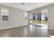 Open living room with tile flooring and sliding glass doors leading to the outdoors at 199 Bull Frog Ln, Umatilla, FL 32784