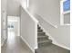 Bright foyer featuring a carpeted staircase with white railing and tiled floors leading into the home at 199 Bull Frog Ln, Umatilla, FL 32784
