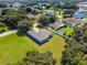 Overhead view of a light blue home on a large, manicured lot in a peaceful, wooded neighborhood at 319 Water Shore Dr, Leesburg, FL 34748