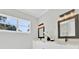 Bright bathroom with double vanity, modern lighting, and a view from the window at 319 Water Shore Dr, Leesburg, FL 34748