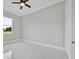 Bright bedroom featuring a ceiling fan, window, white tiled floors and a closet at 319 Water Shore Dr, Leesburg, FL 34748