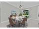 Elegant dining room featuring a decorative table and chairs, and a sliding glass door that fills the room with light at 319 Water Shore Dr, Leesburg, FL 34748