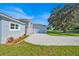 A well-maintained home featuring a stone facade, a wide driveway, and an attached garage with lush greenery at 319 Water Shore Dr, Leesburg, FL 34748