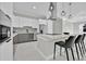 Modern kitchen with stainless steel appliances, a sleek island with seating, and white and gray cabinets at 319 Water Shore Dr, Leesburg, FL 34748