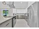 Contemporary kitchen featuring stainless steel appliances, a center island with cooktop, and stylish pendant lighting at 319 Water Shore Dr, Leesburg, FL 34748