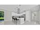 The kitchen features modern white cabinets, a central island with seating, and stainless steel appliances at 319 Water Shore Dr, Leesburg, FL 34748