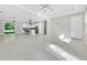 Spacious living room with tile floors, a modern kitchen in the background, and abundant natural light at 319 Water Shore Dr, Leesburg, FL 34748