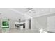 Spacious living room showcasing tiled floors, access to kitchen and a sliding glass door that fills the room with light at 319 Water Shore Dr, Leesburg, FL 34748