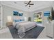 Bright main bedroom featuring a ceiling fan, slider door access to the outdoors, and tasteful decor at 319 Water Shore Dr, Leesburg, FL 34748