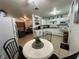 Open kitchen features white cabinets and a view into the living room at 83 Douglas Way, Frostproof, FL 33843