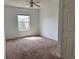 Bedroom with carpeted floor, window, and ceiling fan at 13512 Turtle Marsh Loop # 736, Orlando, FL 32837