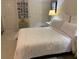 Bedroom with queen bed, nightstand, and double doors at 13512 Turtle Marsh Loop # 736, Orlando, FL 32837