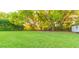 Spacious backyard with lush lawn and mature trees, offering ample shade and privacy at 1380 E Lake Shore Blvd, Kissimmee, FL 34744