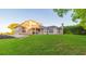 Expansive backyard featuring a well-maintained lawn and covered patio for outdoor relaxation at 1380 E Lake Shore Blvd, Kissimmee, FL 34744
