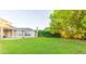 Lush backyard featuring a well-maintained lawn with a covered patio area at 1380 E Lake Shore Blvd, Kissimmee, FL 34744