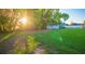 Lush backyard with well-maintained lawn, shed, and privacy fence, creating a serene outdoor space at 1380 E Lake Shore Blvd, Kissimmee, FL 34744