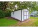 Exterior view of a white shed with double doors, ideal for storage and organization at 1380 E Lake Shore Blvd, Kissimmee, FL 34744