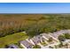 Aerial view of homes with screened pools and solar panels in a wooded area at 1740 N Hampton Dr, Davenport, FL 33897