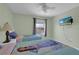 Bright bedroom with two twin beds, ceiling fan, window, and wall-mounted TV at 1740 N Hampton Dr, Davenport, FL 33897