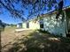 The backyard features a grassy area, a concrete patio, and sliding doors leading into the home at 1928 Drum Dr, Kissimmee, FL 34759