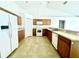 Bright and airy kitchen with wood cabinets and white appliances at 1928 Drum Dr, Kissimmee, FL 34759