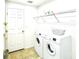 Convenient laundry room includes a washer, dryer, shelving, and a door to the rest of the house at 1928 Drum Dr, Kissimmee, FL 34759