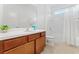 Bathroom with tub shower combo and wood cabinets at 331 Ballo Dr, Kissimmee, FL 34746