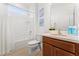 Bathroom with tub shower combo and wood cabinets at 331 Ballo Dr, Kissimmee, FL 34746