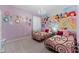 Charming bedroom with twin beds, Disney mural, and chandelier at 331 Ballo Dr, Kissimmee, FL 34746