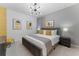 King-size bed with mustard yellow accents and modern art at 331 Ballo Dr, Kissimmee, FL 34746