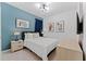 King-size bed, teal accent wall, and modern artwork at 331 Ballo Dr, Kissimmee, FL 34746