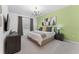 King-size bed, light green accent wall, and modern decor at 331 Ballo Dr, Kissimmee, FL 34746