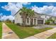 Two-story house with gray exterior, palm trees, and a paved driveway at 331 Ballo Dr, Kissimmee, FL 34746