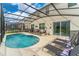 Screened-in pool area with lounge chairs and patio furniture at 331 Ballo Dr, Kissimmee, FL 34746