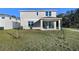 Home's backyard with covered patio and grassy area at 4200 Sawtooth Ct, Tavares, FL 32778