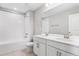 Bathroom with double vanity, large mirror, and shower/tub combo at 4200 Sawtooth Ct, Tavares, FL 32778