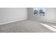Bright bedroom with neutral walls and carpeted floors and large window at 4200 Sawtooth Ct, Tavares, FL 32778