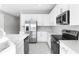 Modern kitchen with white cabinets and stainless steel appliances at 4200 Sawtooth Ct, Tavares, FL 32778