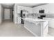 Modern kitchen with white cabinets, stainless steel appliances, and an island at 4200 Sawtooth Ct, Tavares, FL 32778