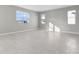 Spacious living room with gray walls and tile flooring, featuring large windows at 4200 Sawtooth Ct, Tavares, FL 32778