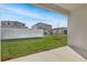 Spacious backyard with a white fence, a well-maintained lawn, and neighboring houses at 4224 Sawtooth Ct, Tavares, FL 32778