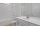 Clean bathroom with white tile, vanity, and modern fixtures in neutral colors at 4224 Sawtooth Ct, Tavares, FL 32778